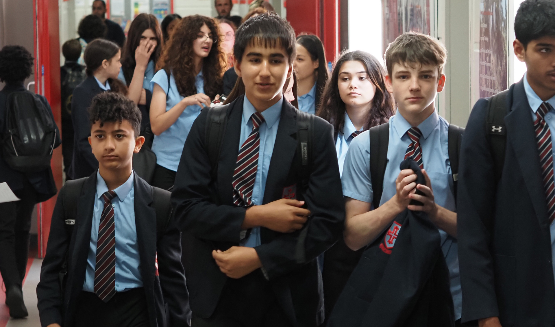 Image of a classroom with a teacher at the whiteboard.