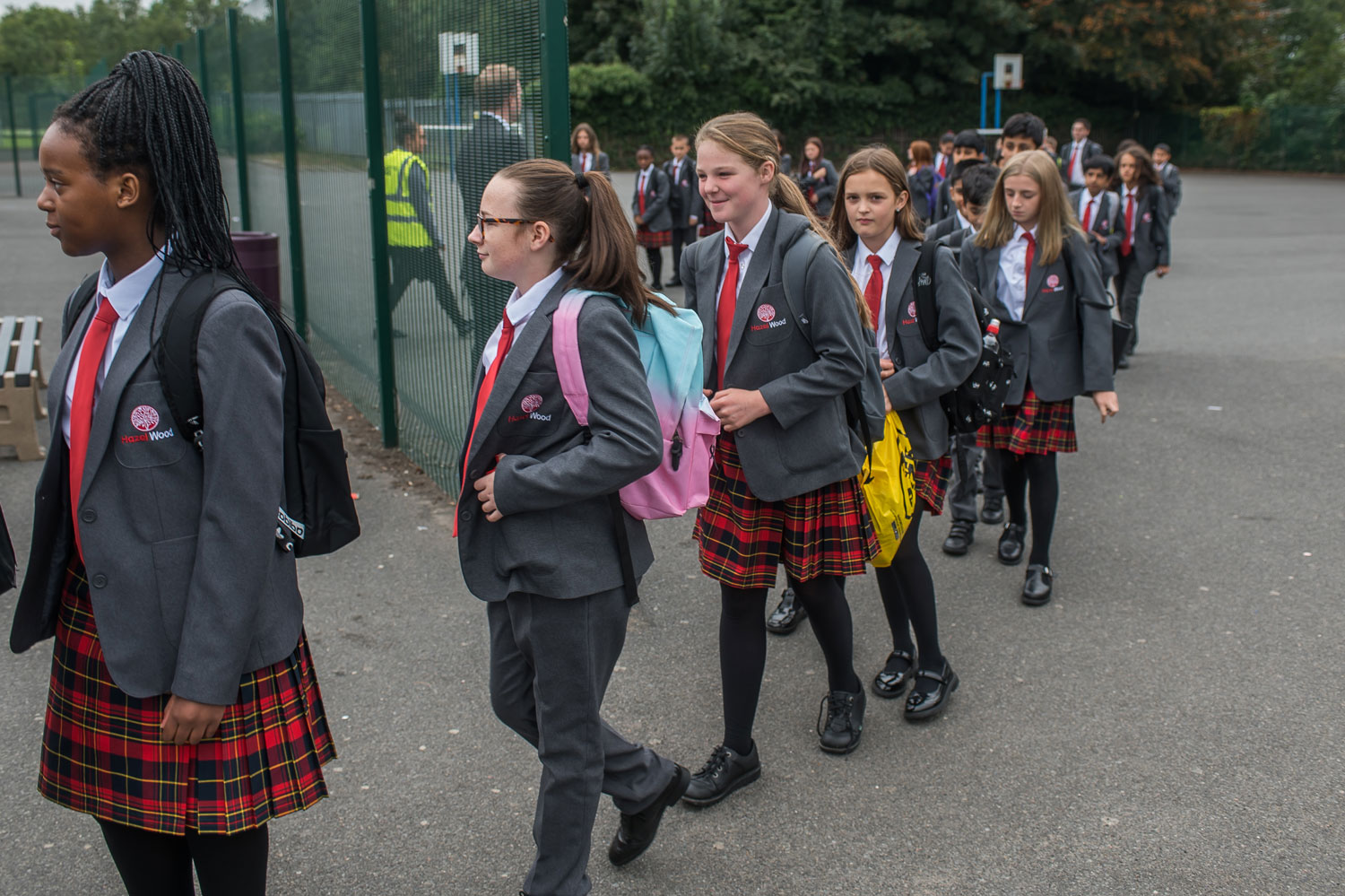 Image of a children walking into the grounds of a school.
